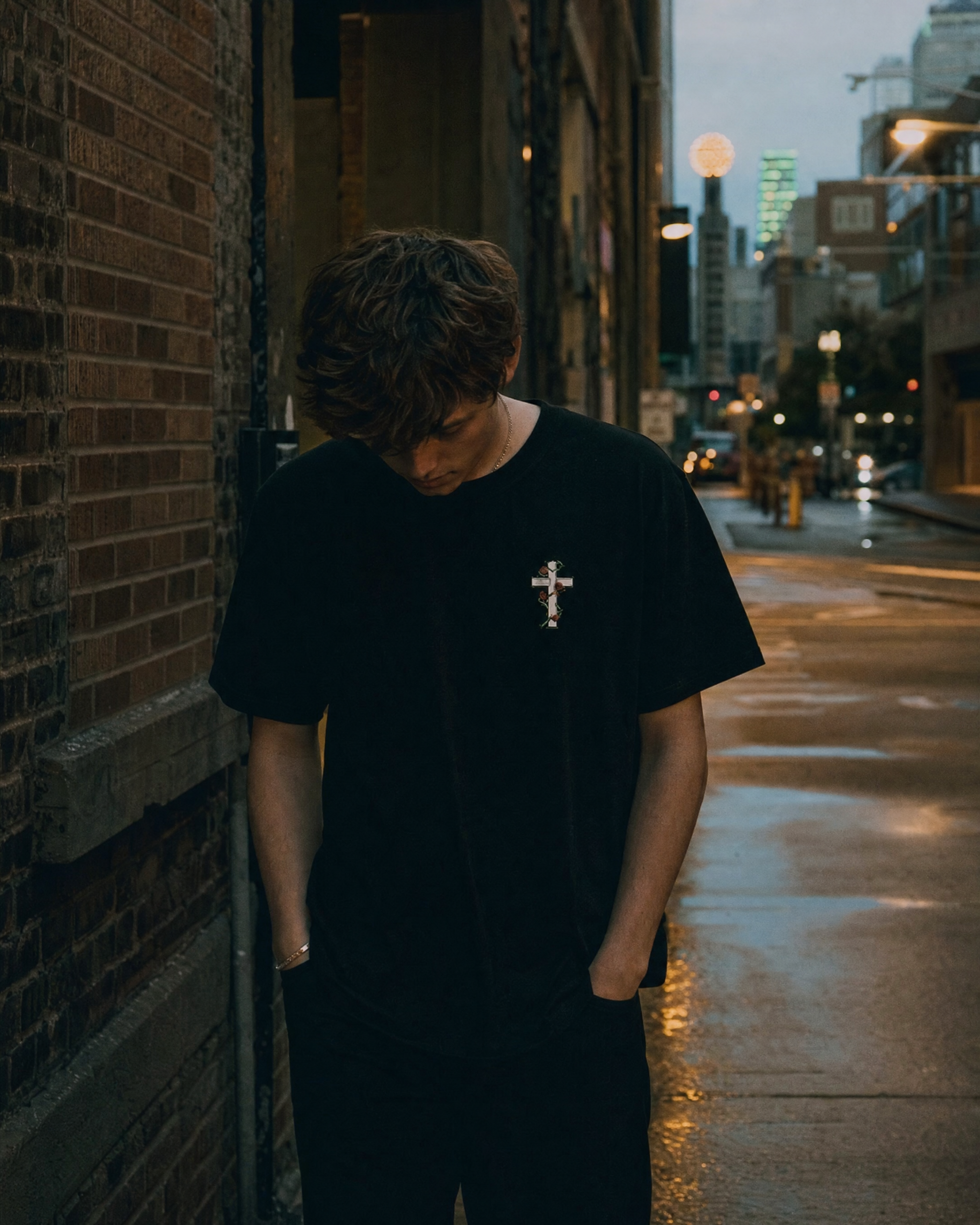 Walk Through the Thorns: Cross Tee Black on urban Dallas street